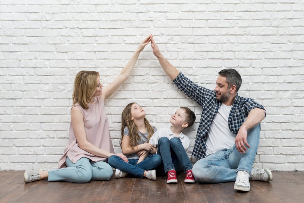 Happy family gathered together, with children laughing while enjoying riddles